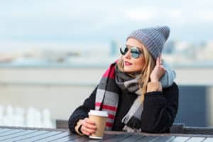 Wearing stylish black oversized coat scarf sunglasses and hat